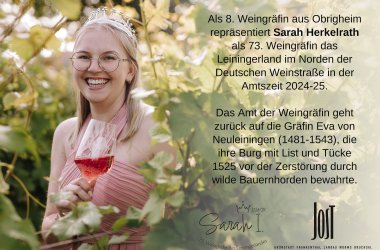 Weingräfin Sarah, stehend zwischen Weinlaub, mit Weinglas in der Hand